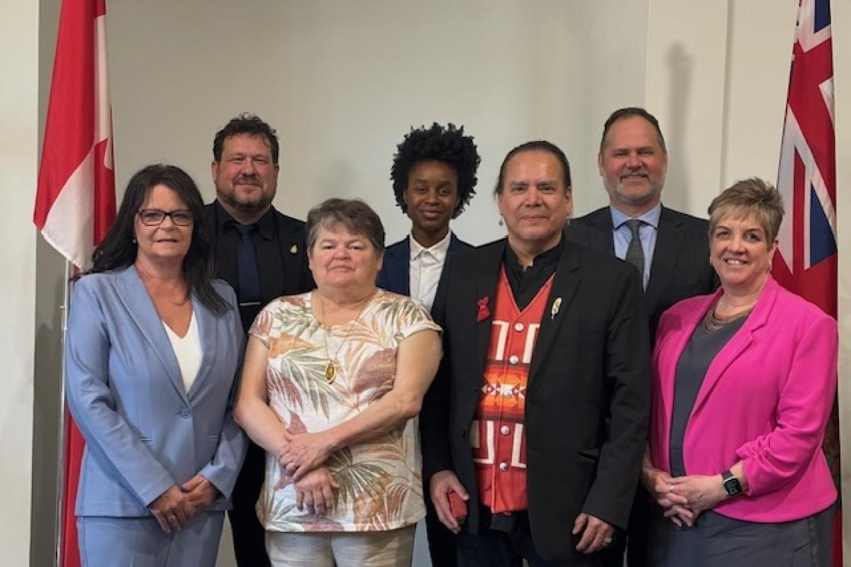 The NACC Presidents stands with six Manitoba Ministers at a Parliamentary meeting. 