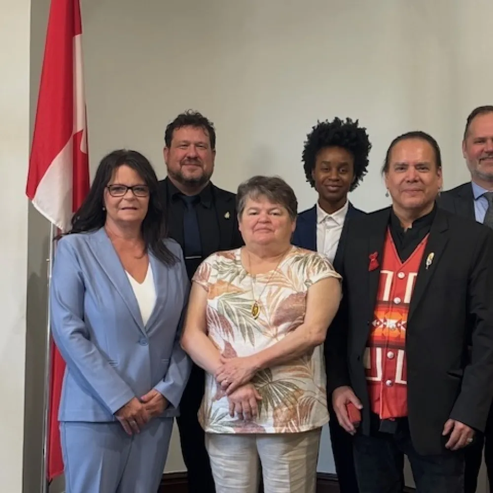 The NACC Presidents stands with six Manitoba Ministers at a Parliamentary meeting. 